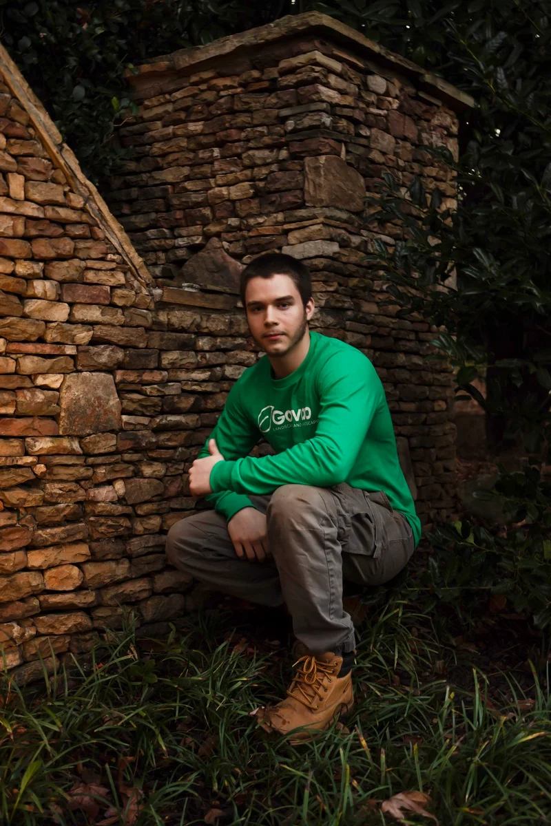 Galvao crew member at a hand-laid stone retaining wall